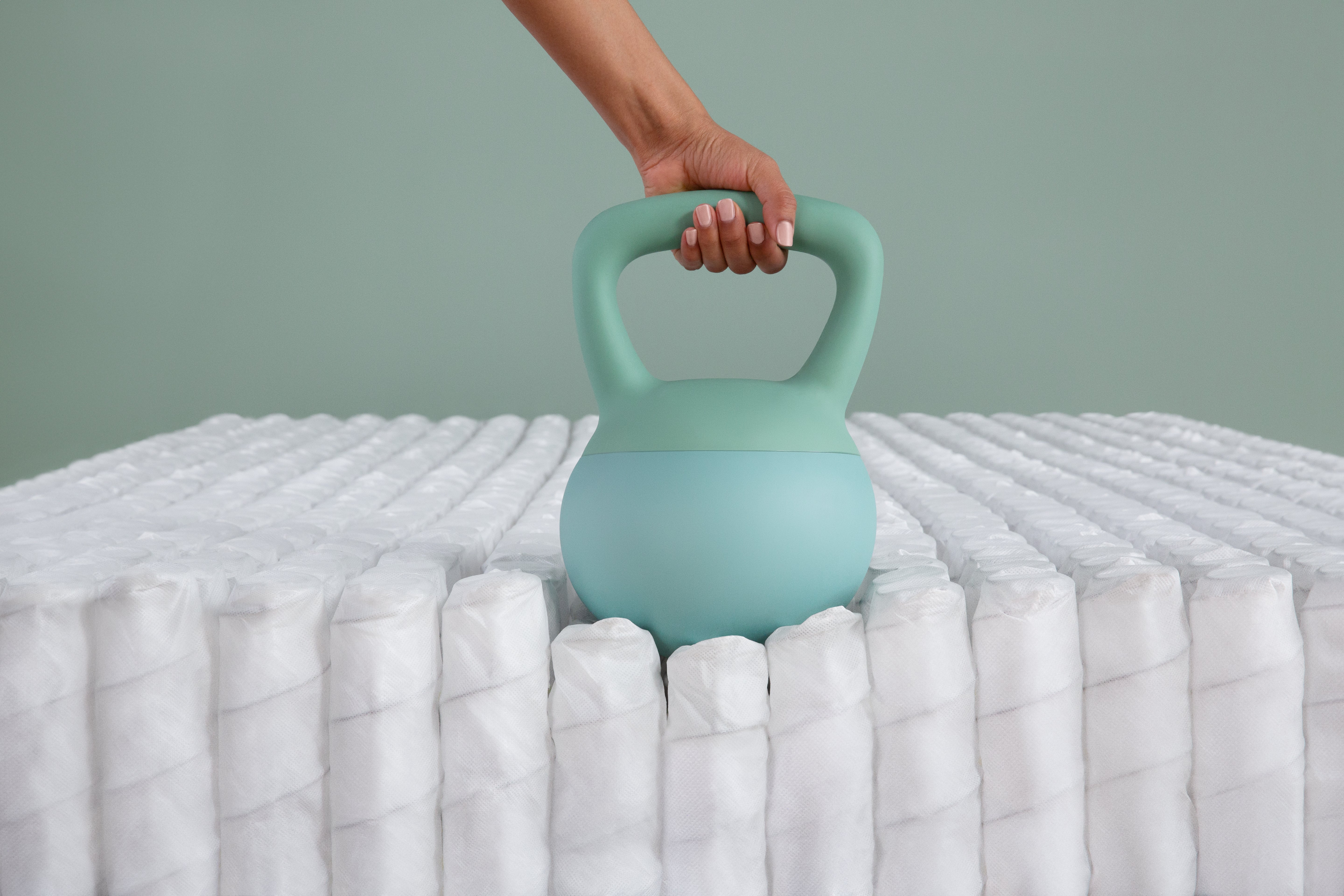 Beautyrest Beautysleep pocket coils with kettlebell sittng on them showing no motion transfer