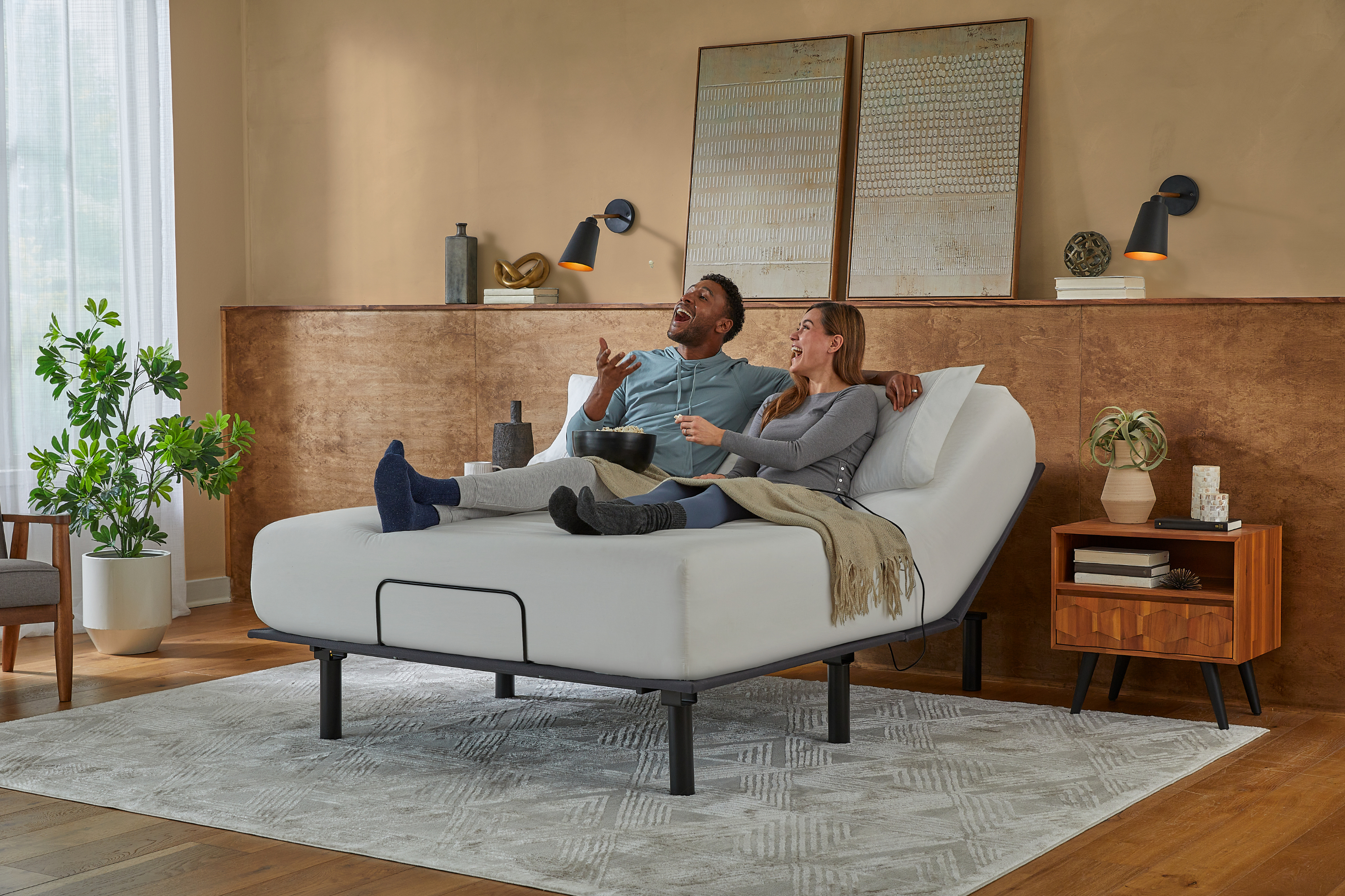 Couple relaxing on a adjustable bed in a modern bedroom.