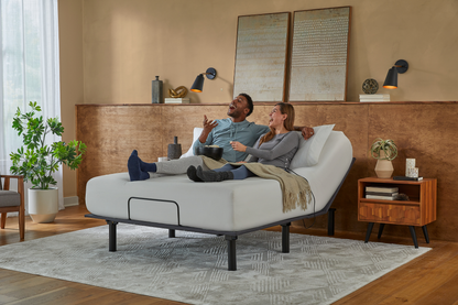 Couple relaxing on a adjustable bed in a modern bedroom.