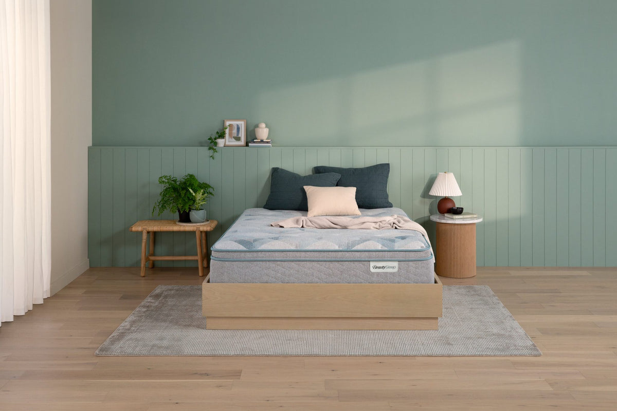 Beautyrest Beautysleep Keegan Plush mattress with Pillow Top in room setting sitting on wooden foundation