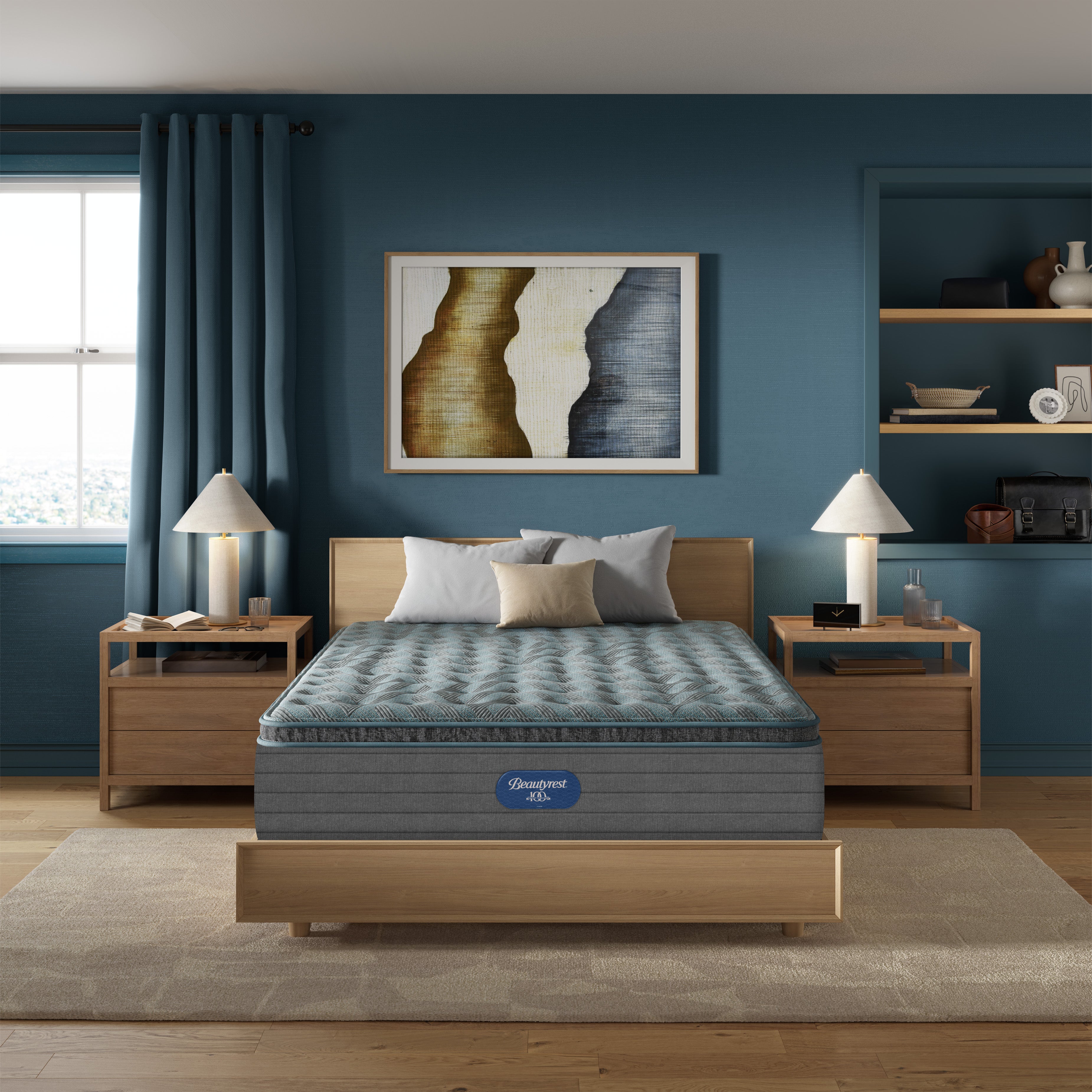 Front room view of Beautyrest Eryx Medium pillow top mattress sitting on wooden bed frame with wooden nightstands wtih blue wall and blue curtains