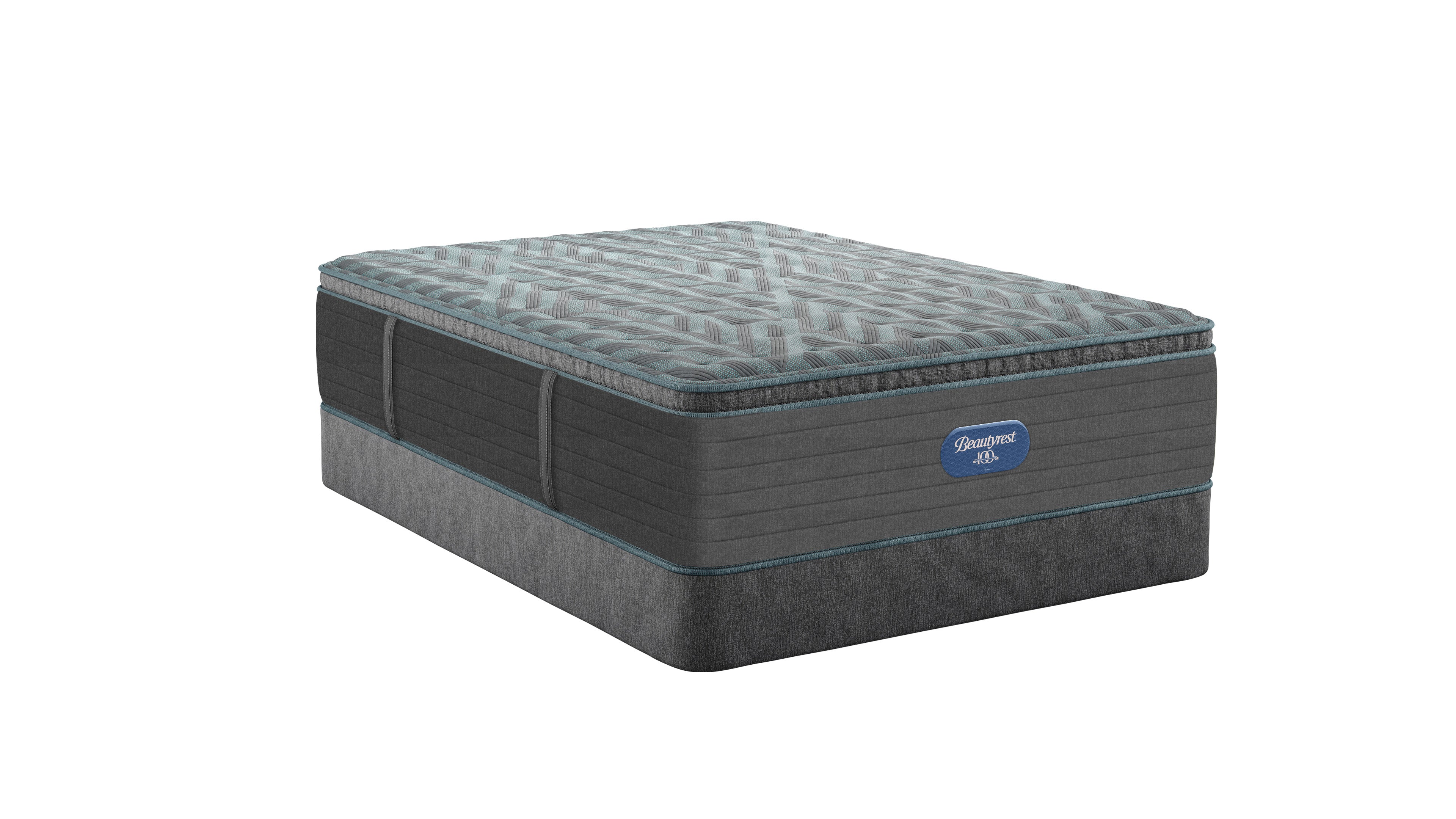 Side angle view of Beautyrest Eryx Medium Pillow top mattress sitting on grey foundation